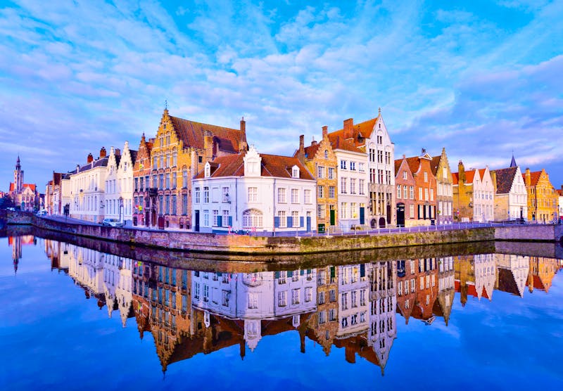 Traditional architecture in Bruges town, reflected in water at sunrise - ©©cristianbalate - stock.adobe.com
