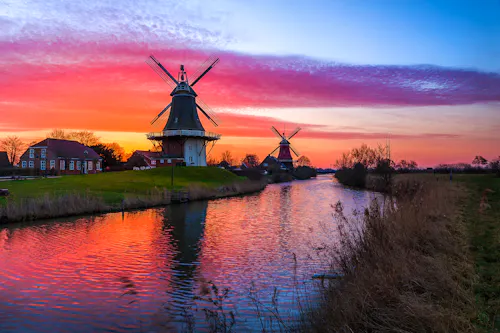 Greetsiel in Ostfriesland - die Zwillings-Windmühlen im Abendrot &ndash; &copy; rphfoto - stock.adobe.com