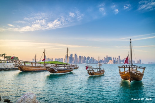 Dhows moored off Museum Park in central Doha, Qatar, Arabia, with some of the buildings from the city's commercial port in the background. – © matpit73 - Fotolia