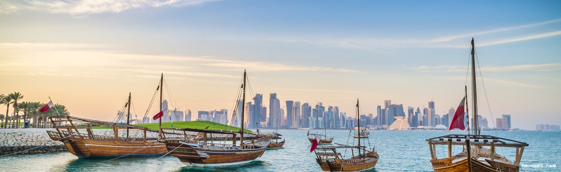Dhows moored off Museum Park in central Doha, Qatar, Arabia, with some of the buildings from the city's commercial port in the background. – © matpit73 - Fotolia