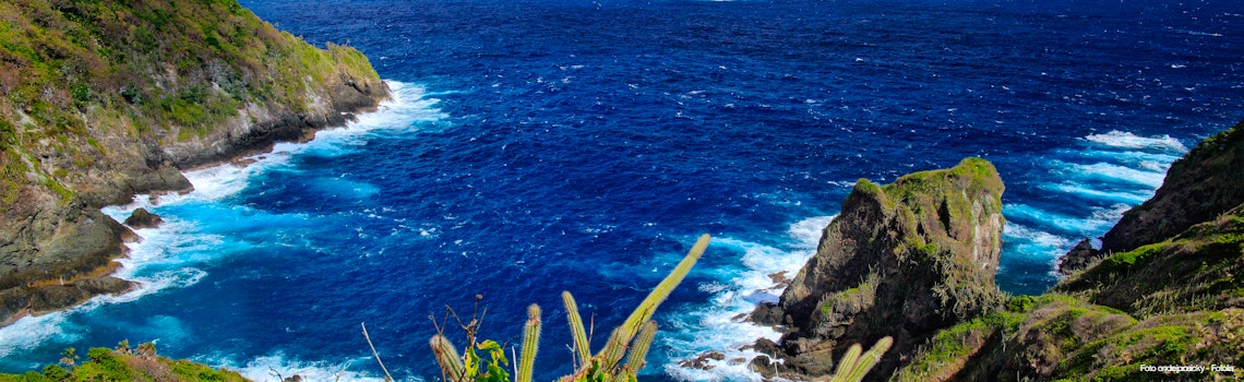 Little Tobago Island  Beautiful Caribbean sea coast landscape with ocean and dark sky with white clouds  Dark blue sea with waves  Coastline with cliff and rough sea  Trinidad and Tobago   – © ondrejprosicky - Fotolia