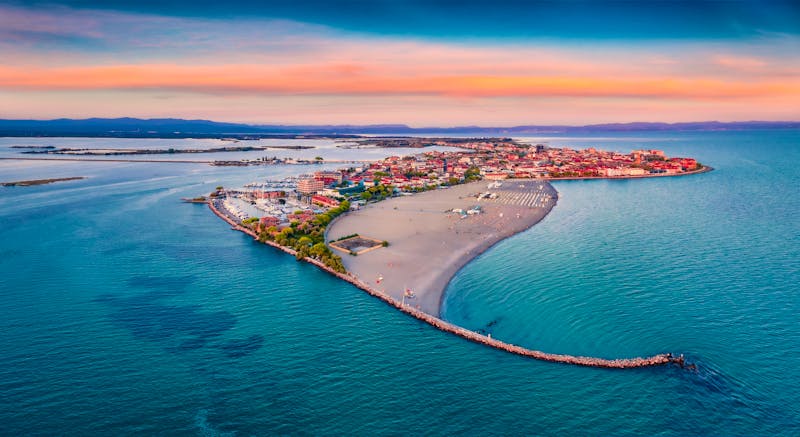 Beautiful summer scenery  Breathtaking summer view  from flying drone of public beach of Grado port  small town located between Venice and Trieste  Magnificent evening seascape of Adriatic sea  - ©Andrew Mayovskyy - stock.adobe.com