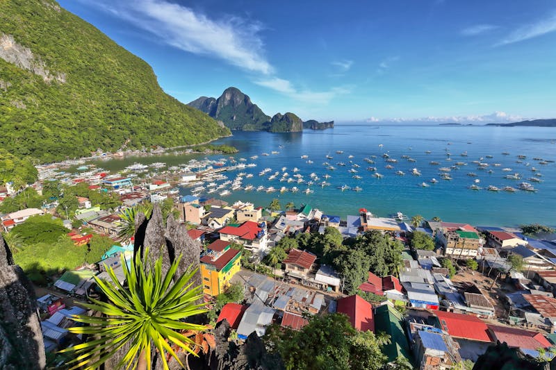 Northwards view from the observation deck at Taraw cliff over central El Nido town or Poblacion and further to the tourboat crowded port and bay with Cadlao island on background  Palawan-Philippines  - ©rweisswald - stock.adobe.com