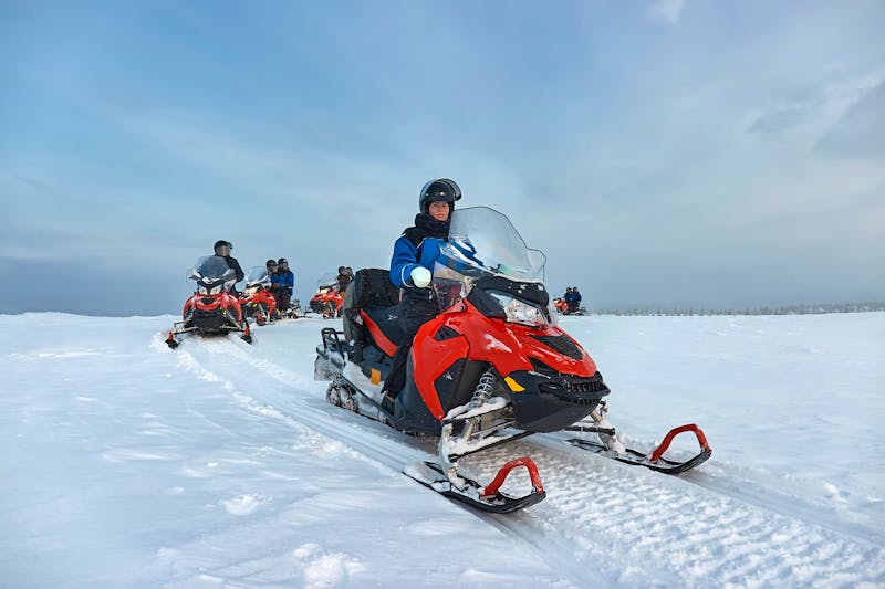 Riding on a snowmobile in Finland  female rider above the Arctic Circle - &copy;Gudellaphoto - stock.adobe.com